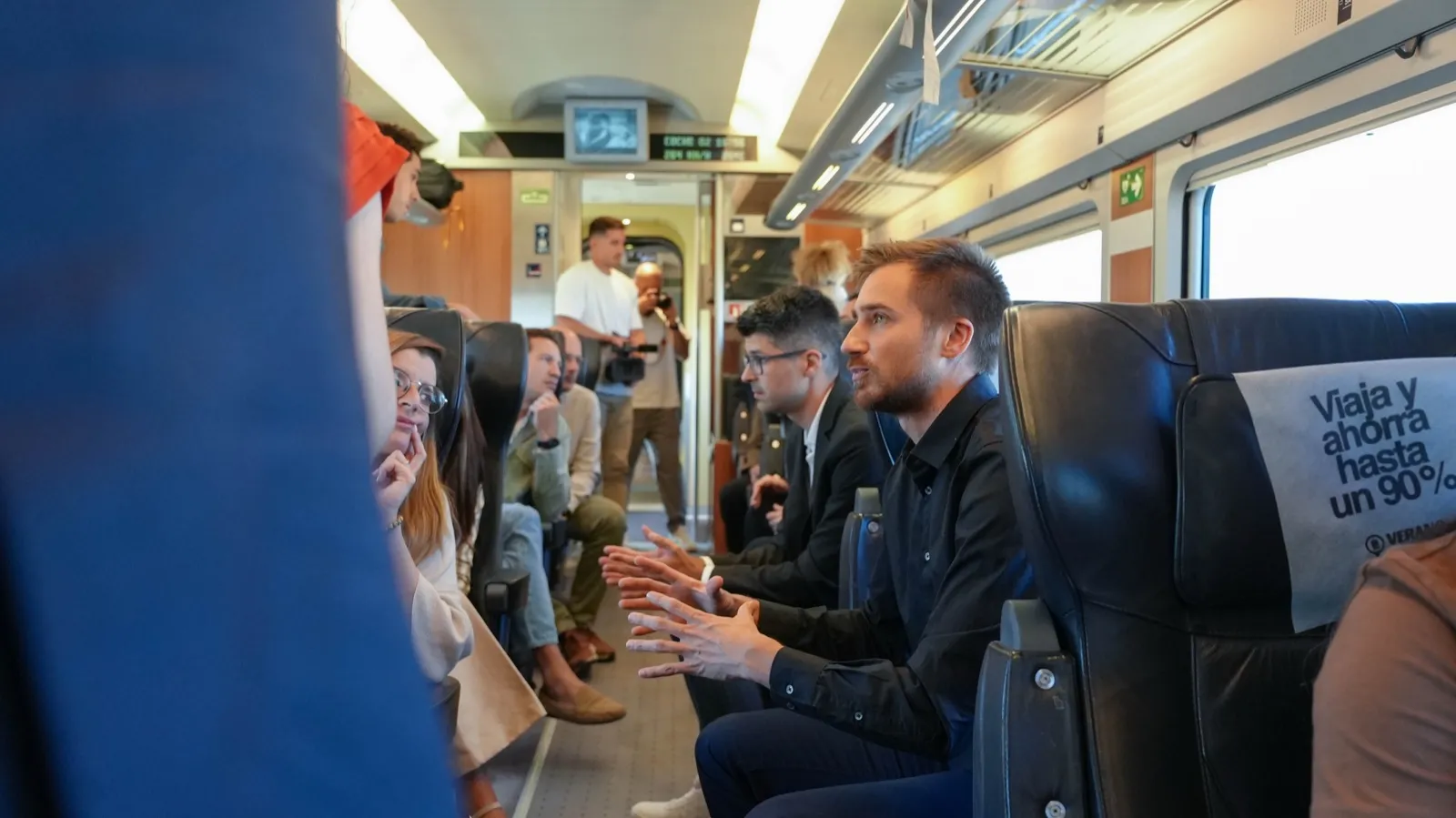 Jakob fent el pitch als altres passatgers a bord del tren de pitches de Renfe, setembre del 2025.